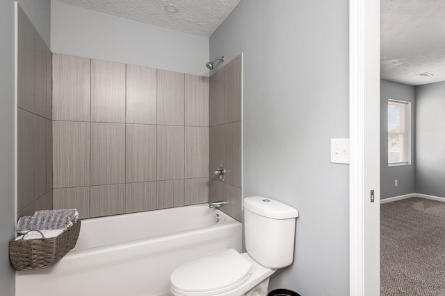 bathroom with shower / tub combination, a textured ceiling, and toilet