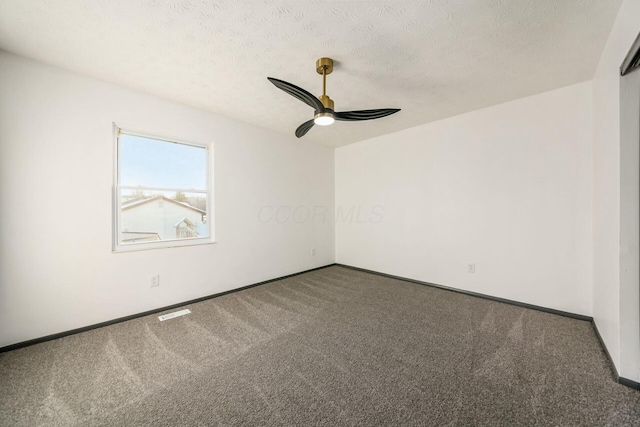 carpeted empty room featuring a textured ceiling and ceiling fan