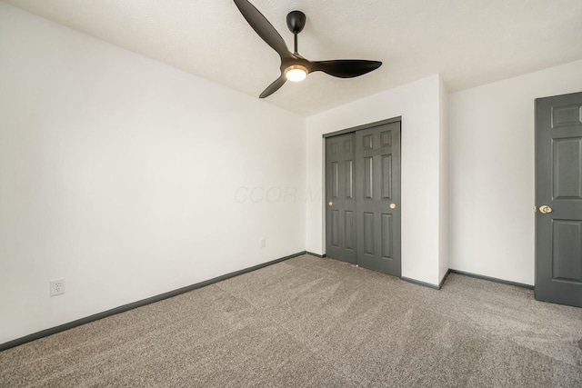 unfurnished bedroom with ceiling fan, light colored carpet, and a closet