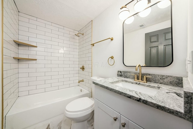 full bathroom featuring a textured ceiling, vanity, tiled shower / bath combo, and toilet