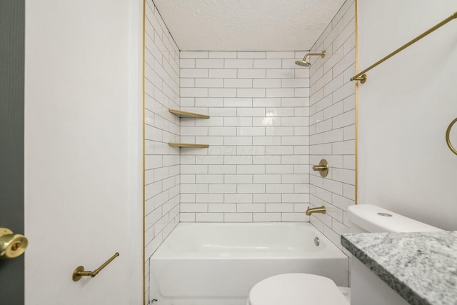 full bathroom featuring tiled shower / bath combo, toilet, a textured ceiling, and vanity