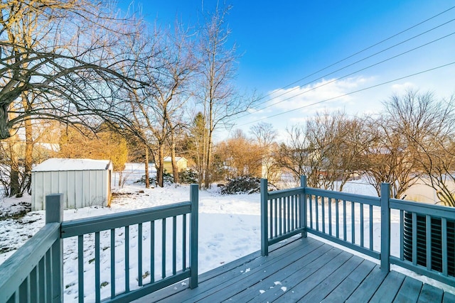 snow covered deck with a storage unit