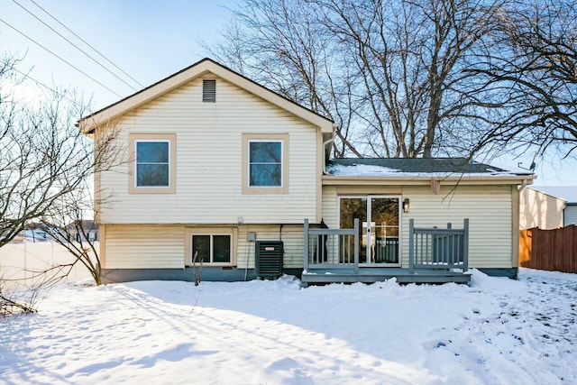 snow covered property featuring a deck and central AC unit