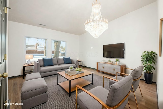 living room featuring hardwood / wood-style floors and a notable chandelier