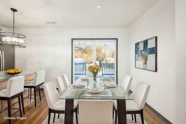 dining space featuring a chandelier and hardwood / wood-style flooring