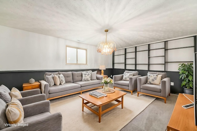 living room with a chandelier, a textured ceiling, and light colored carpet