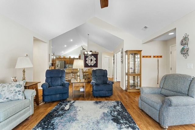 living room featuring vaulted ceiling and hardwood / wood-style floors