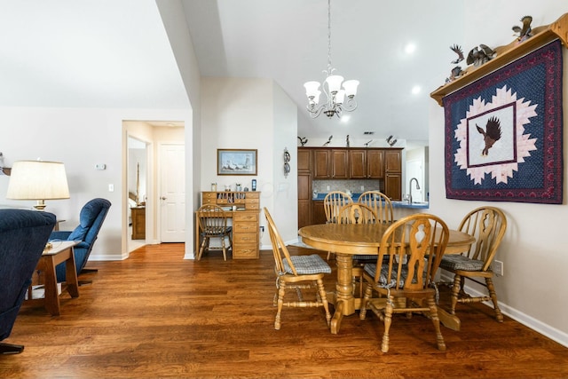 dining space featuring an inviting chandelier, sink, and dark hardwood / wood-style floors