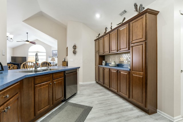 kitchen with lofted ceiling, sink, light hardwood / wood-style flooring, stainless steel dishwasher, and decorative backsplash