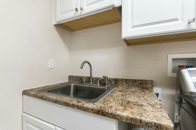 kitchen featuring sink and white cabinets