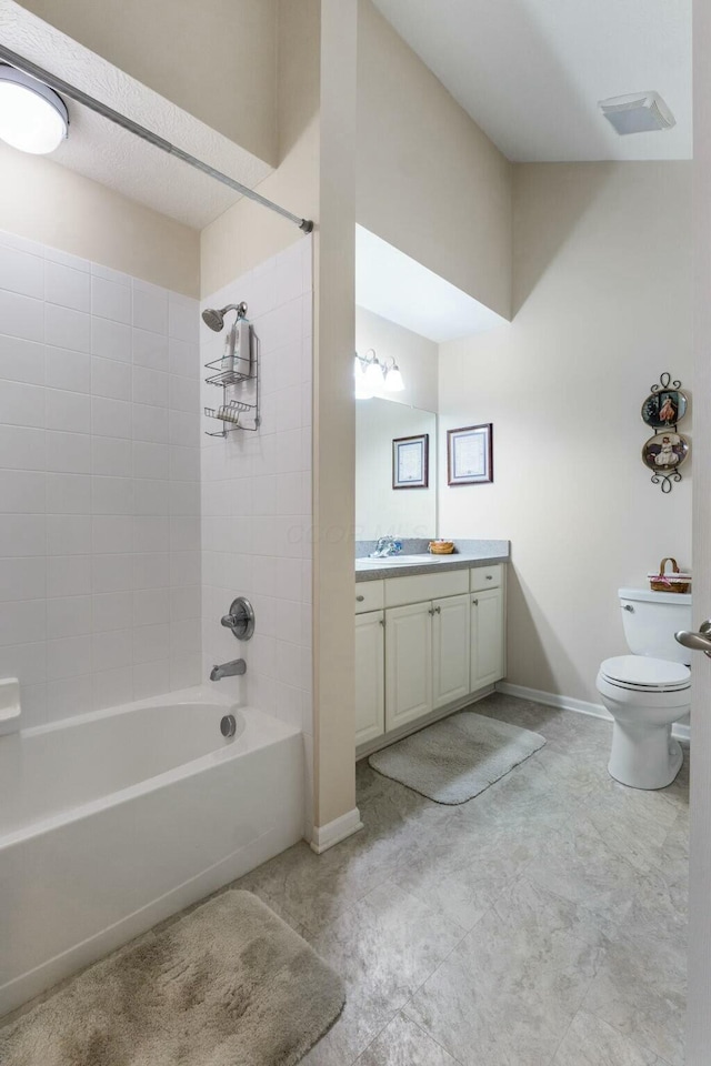 full bathroom featuring tiled shower / bath combo, vanity, and toilet