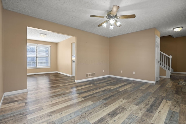 unfurnished room with ceiling fan, dark wood-type flooring, and a textured ceiling