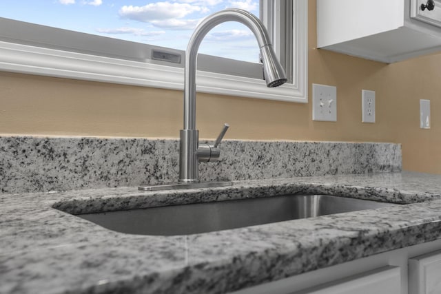 interior details with sink and white cabinets