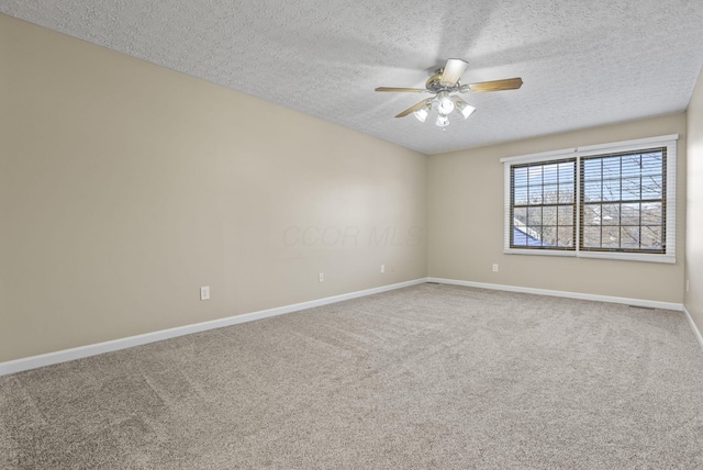 spare room with ceiling fan, carpet floors, and a textured ceiling