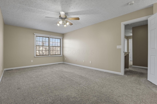 carpeted empty room with ceiling fan and a textured ceiling