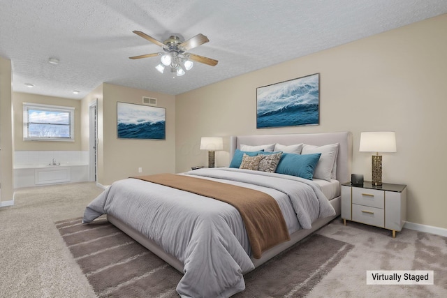 carpeted bedroom with ceiling fan, connected bathroom, and a textured ceiling