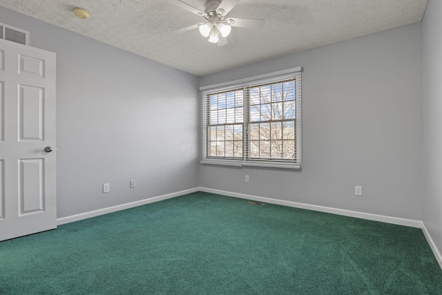 carpeted empty room featuring ceiling fan and a textured ceiling