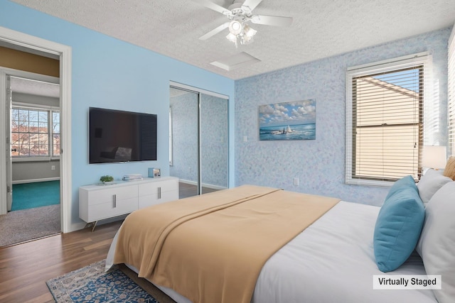 bedroom featuring hardwood / wood-style floors, a textured ceiling, a closet, and ceiling fan