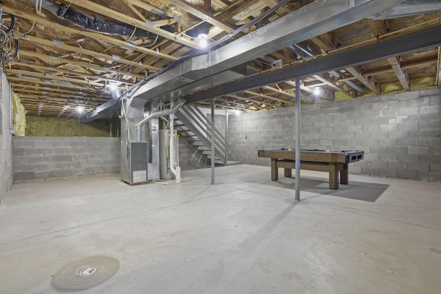 basement featuring water heater and heating unit