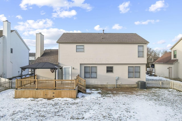 snow covered back of property with a gazebo, a wooden deck, and cooling unit