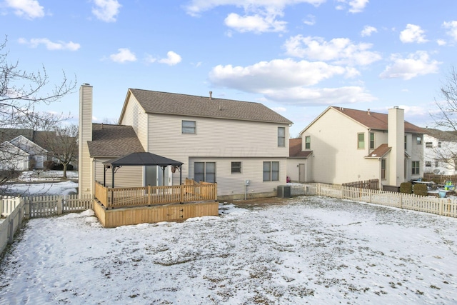 snow covered property with a gazebo, central air condition unit, and a deck