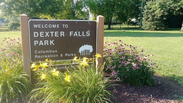 community / neighborhood sign with a lawn