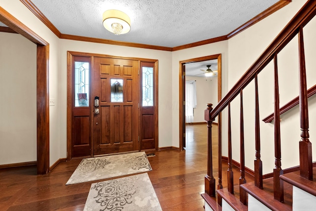 entryway featuring a textured ceiling, dark hardwood / wood-style floors, and crown molding