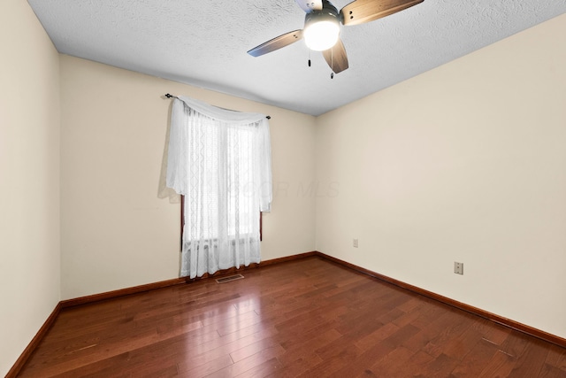 spare room featuring ceiling fan, wood-type flooring, and a textured ceiling