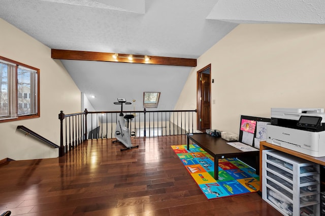 game room featuring wood-type flooring, vaulted ceiling with beams, and a textured ceiling