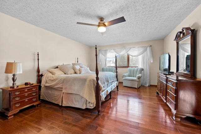 bedroom featuring a textured ceiling, dark hardwood / wood-style floors, and ceiling fan