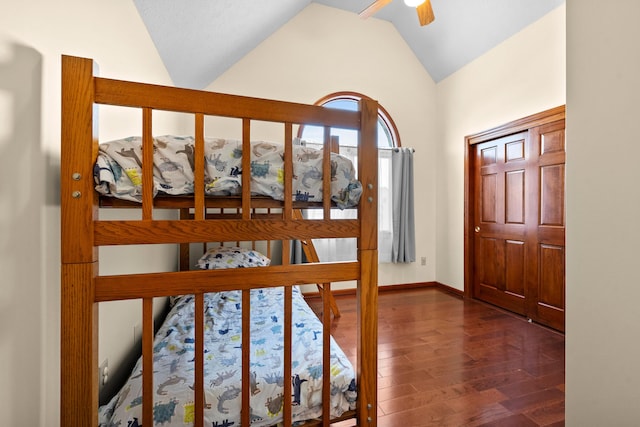 entrance foyer with ceiling fan, dark hardwood / wood-style flooring, and vaulted ceiling