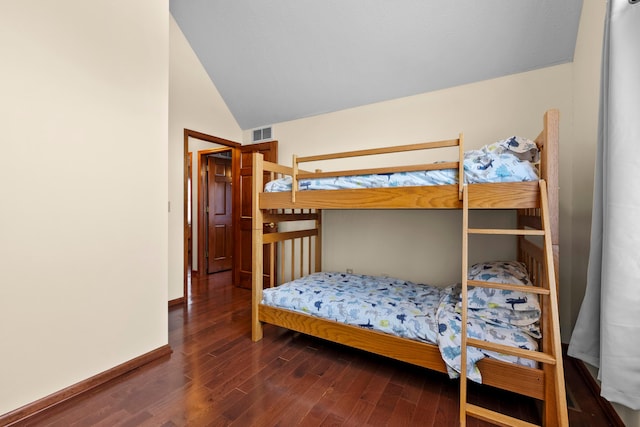 bedroom with dark hardwood / wood-style flooring and vaulted ceiling