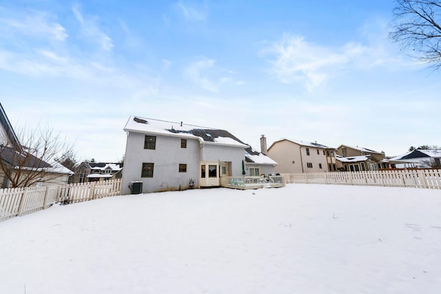 snow covered property featuring a deck and central AC unit