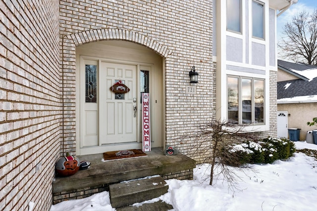 view of snow covered property entrance