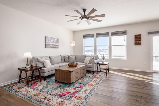 living room with hardwood / wood-style floors, a textured ceiling, and ceiling fan