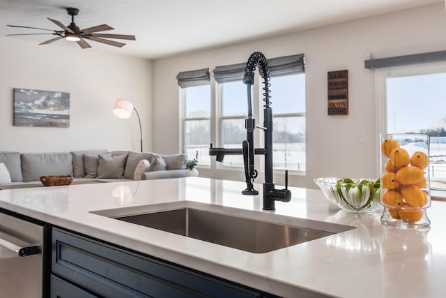 kitchen featuring sink, dishwasher, ceiling fan, and a healthy amount of sunlight