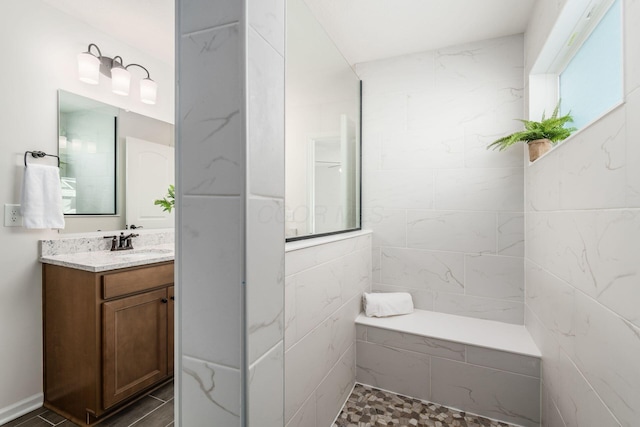 bathroom with a shower and vanity