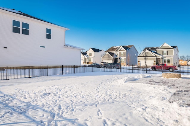 snowy yard featuring a garage