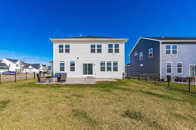 back of house featuring a patio, a lawn, a residential view, and a fenced backyard