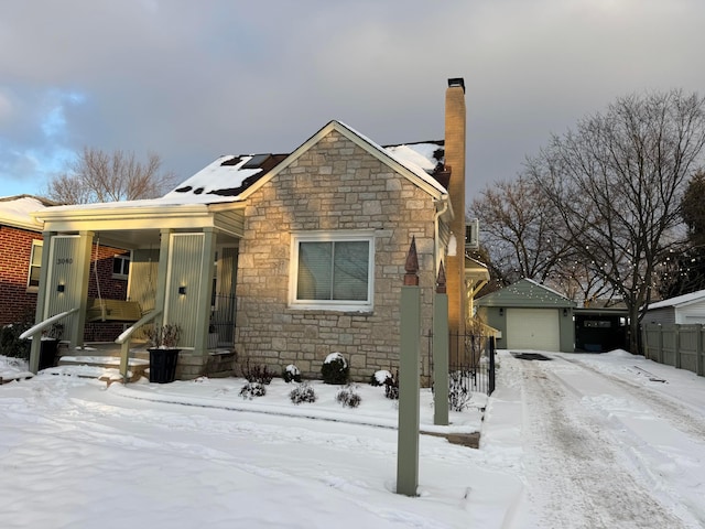 view of front of property with a garage and an outdoor structure