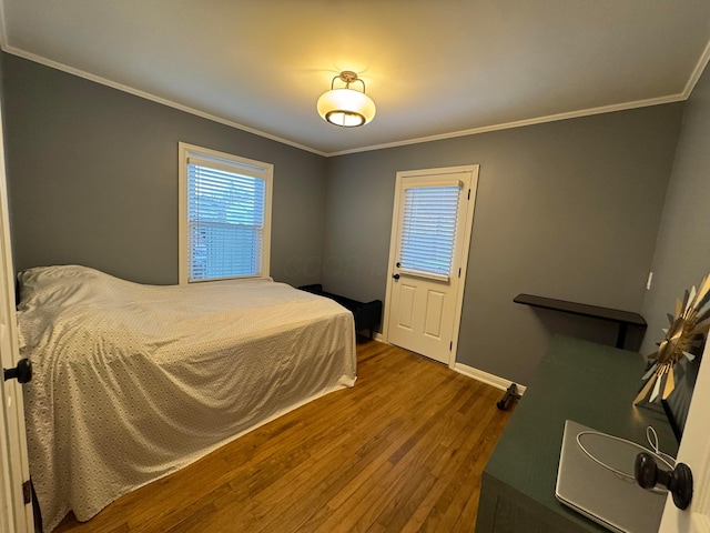 bedroom featuring wood-type flooring and crown molding