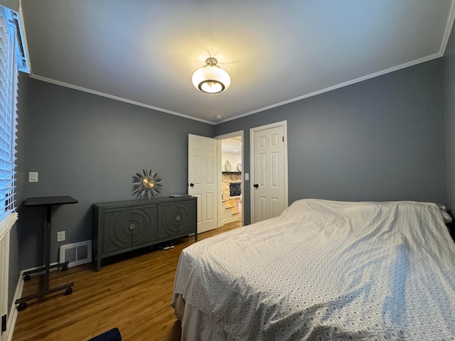 bedroom featuring crown molding and hardwood / wood-style flooring