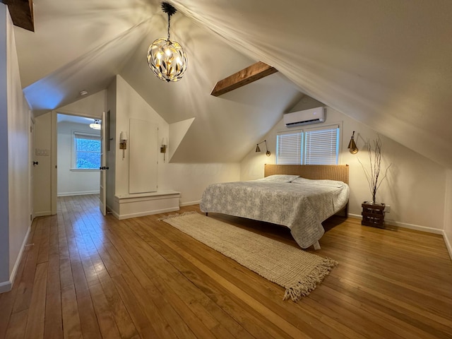 bedroom with hardwood / wood-style flooring, lofted ceiling, and a wall mounted AC