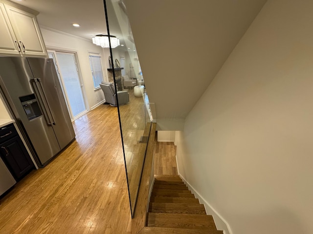 staircase with hardwood / wood-style floors