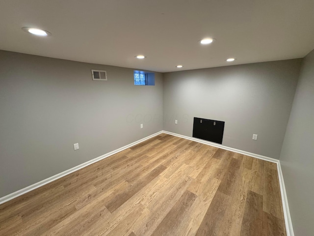 basement with light hardwood / wood-style floors