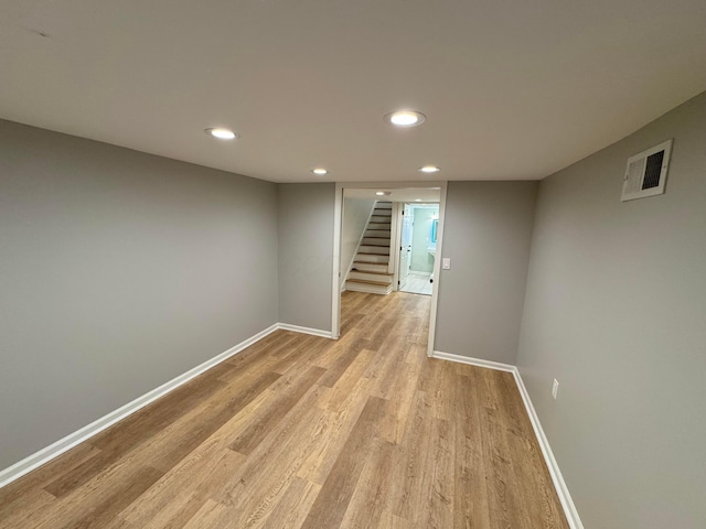 basement with light hardwood / wood-style floors