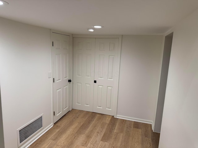 interior space featuring multiple closets and light wood-type flooring