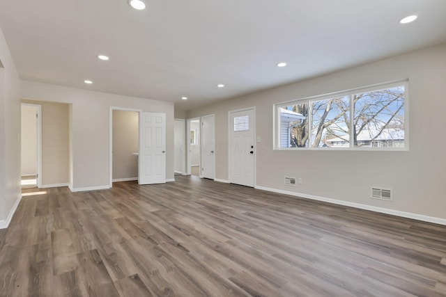 unfurnished living room with wood-type flooring