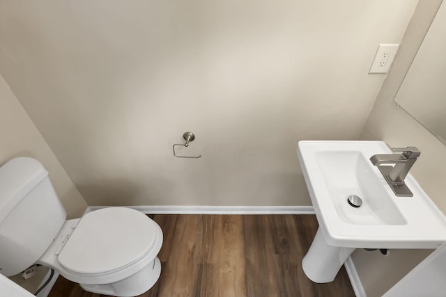 bathroom featuring sink, hardwood / wood-style floors, and toilet