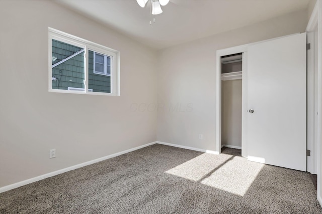 unfurnished bedroom with carpet flooring, ceiling fan, and a closet